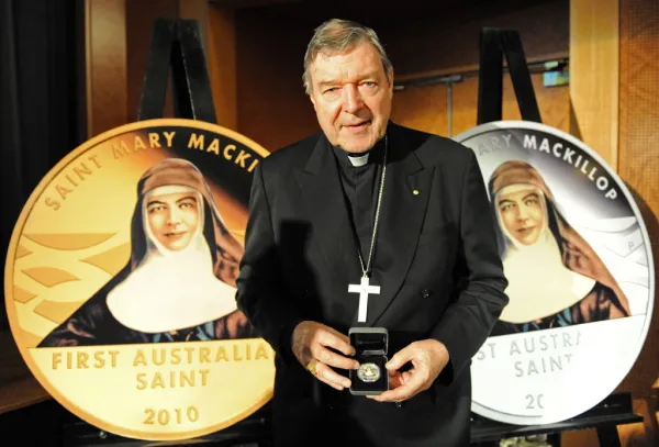 Cardinal George Pell, archbishop of Sydney, unveils Australia's first pure gold (L) and silver (R) coins commemorating the canonization of Mary MacKillop in Sydney on Sept. 30, 2010. Photo by TORSTEN BLACKWOOD/AFP via Getty Images