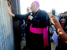 Robert W. McElroy, Archbishop of San Diego speaks with participants through the fence during the 23rd Posada Sin Fronteras where worshipers gather on both sides of the US-Mexican border fence for a Christmas celebration, at Friendship Park and Playas de Tijuana in San Ysidro, California on December 10, 2016.