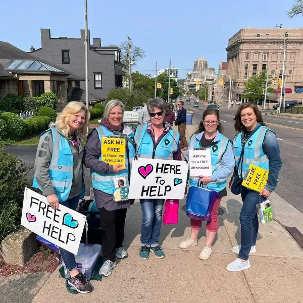 Sidewalk advocates gather with signs and gift bags for women in Grand Rapids, Michigan. Credit: Photo courtesy of Sidewalk Advocates for Life.