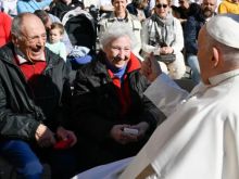 Pope Francis greets an elderly couple at a general audience in St. Peter's Square at the Vatican.