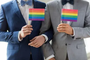 Grooms with rainbow flags