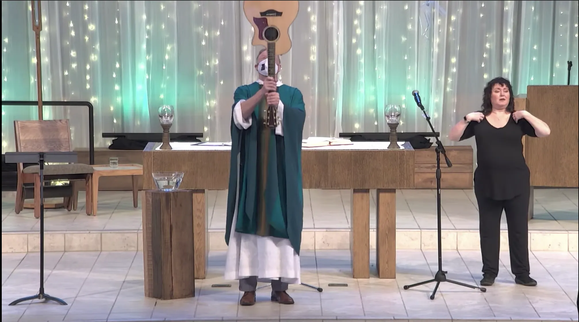 Father Terrence M. Keehan, pastor of Holy Family Catholic Church in Inverness, Illinois, using a guitar to give the final blessing at a Mass livestreamed on Feb. 13, 2022.?w=200&h=150