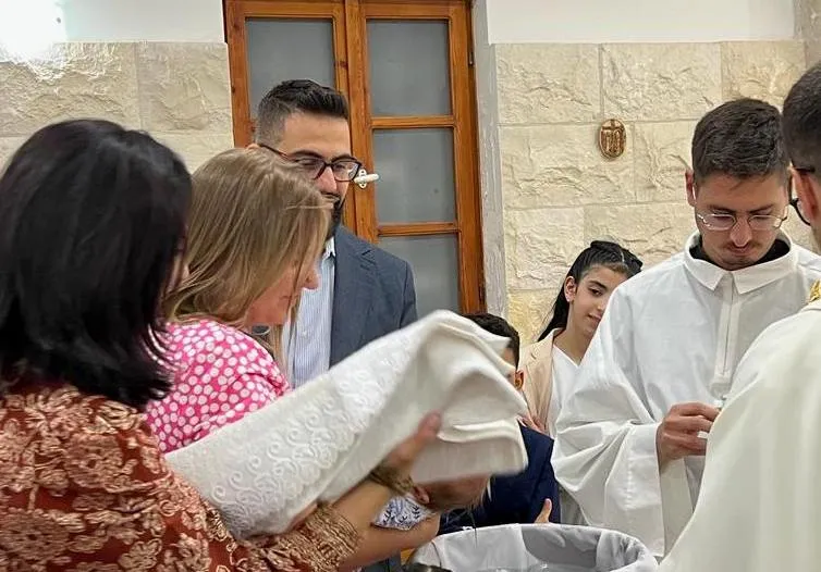 Hussam Abu Sini and Chiara Pezzulich bring their daughter, Marta, to be baptized on Thursday, Oct. 19, 2023, in St. John the Baptist Catholic Church in Haifa, Israel.?w=200&h=150