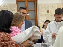 Hussam Abu Sini and Chiara Pezzulich bring their daughter, Marta, to be baptized on Thursday, Oct. 19, 2023, in St. John the Baptist Catholic Church in Haifa, Israel.
