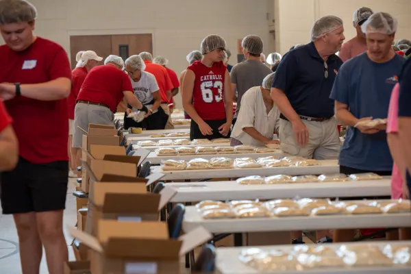 Teams of approximately eight people assemble ready-to-cook meals for the poor in Haiti at the Monsignor McSweeney World Hunger Drive on Aug. 12, 2023, at St. Matthew Catholic Church in Charlotte, North Carolina. Each cardboard box, when filled, contains 216 meals. Phillip Budidharma/CNA