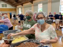 Volunteers pack meals for families in Haiti at St. Cecilia parish in Wilbraham, Mass., May 2022.