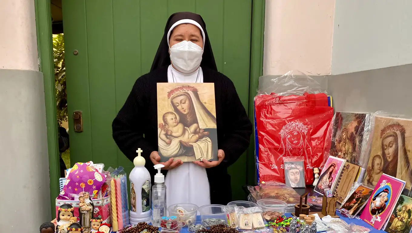 A member of the Dominican Sisters’ Congregation of St. Rose of Lima in northern Italy sells prints at the Santa’s Sanctuary of Lima.