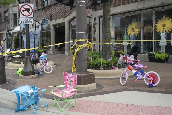 Police crime tape is seen around the area where children's bicycles and baby strollers stand near the scene of the Fourth of July parade shooting in Highland Park, Illinois, on July 4, 2022. Youngrae Kim/AFP via Getty Images