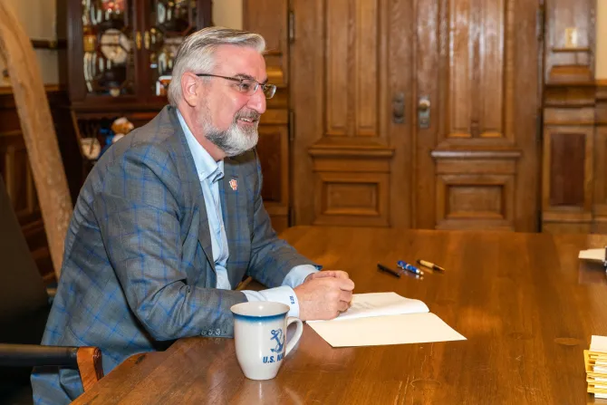 Indiana Governor Eric Holcomb signs bills in Indianapolis, March 10, 2022.