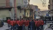 Men process with the historic cross on the feast of the Holy Cross in Montemaggiore Belsito on Sept. 14, 2022. It is considered a great honor to be one of the people to transport the heavy float in which the cross is carried.