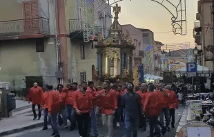 Men process with the historic cross on the feast of the Holy Cross in Montemaggiore Belsito on Sept. 14, 2022. It is considered a great honor to be one of the people to transport the heavy float in which the cross is carried. Credit: Hannah Brockhaus/CNA