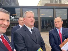 Mark Houck talks to reporters outside the U.S. District courthouse in Philadelphia with his lawyers, Peter Breen (left), Brian McMonagle (right), and Andrew Bath (background) following his acquittal on two charges of violating the FACE Act, Jan. 30, 2023.