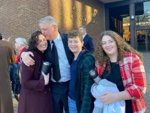 After being acquitted of federal charges by a jury in Philadelphia on Monday, Jan. 30, 2023, Mark Houck embraces and kisses his wife, Ryan-Marie Houck. Also with Houck are his son Mark Houck Jr., 14, and his daughter, Ava Houck, 12.