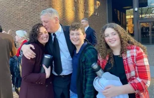 After being acquitted of federal charges by a jury in Philadelphia on Monday, Jan. 30, 2023, Mark Houck embraces and kisses his wife, Ryan-Marie Houck. Also with Houck are his son Mark Houck Jr., 14, and his daughter, Ava Houck, 12. Joe Bukuras/CNA