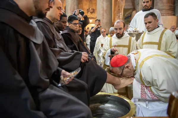 Cardinal Pierbattista Pizzaballa, the Latin Patriarch of Jerusalem, kisses the feet of a Franciscan friar during the "Washing of the Feet" ritual at the Mass of the Lord's Supper celebrated at the Holy Sepulchre on Holy Thursday. The celebration is held on Thursday morning due to the Status Quo. March 28, 2024. Courtesy of the Custody of the Holy Land