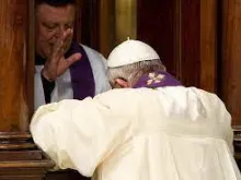 Pope Francis confesses in St. Peter's Basilica.