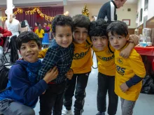 Children of Afghan immigrants to St. Louis play during a holiday party on Dec. 9, 2023.