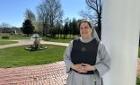 Mother Marla Marie stands on the front porch of the sisters’ Mother of the Light convent in Dartmouth, Massachusetts.