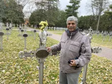 Patrick Norton stands near Sister Annella Zervas' grave, October 2022.