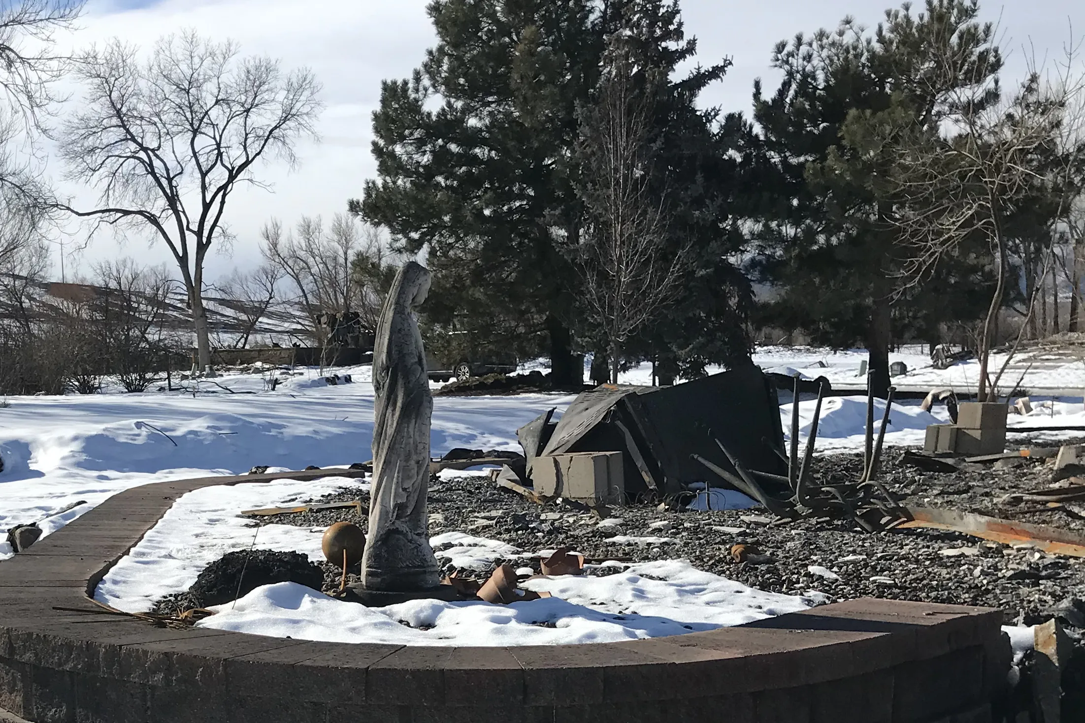 A concrete statue of Mary stands near the burned home of the McLaren family in Superior, Colorado after the Dec. 30, 2021 Marshall Fire.?w=200&h=150