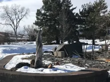 A concrete statue of Mary stands near the burned home of the McLaren family in Superior, Colorado after the Dec. 30, 2021 Marshall Fire.