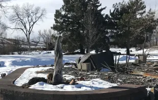 A concrete statue of Mary stands near the burned home of the McLaren family in Superior, Colorado after the Dec. 30, 2021 Marshall Fire. Bob and Tina McLaren