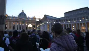 Pilgrims pray in front of St. Peter's Basilica