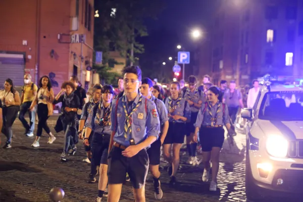 Pilgrims, including scouts, walk through Rome's Ostiense neighborhood. Hannah Brockhaus
