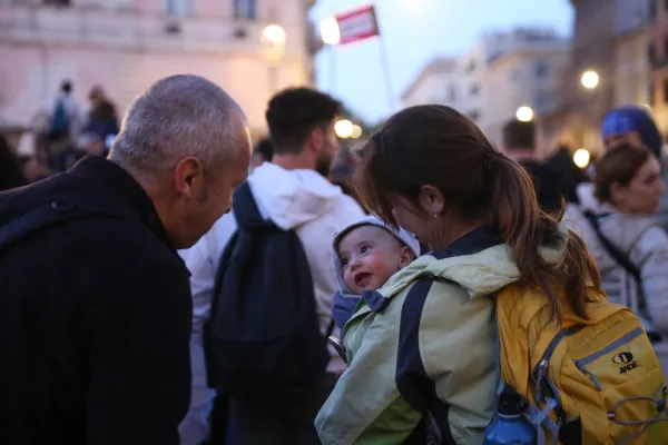 A baby and his mom enjoy a moment with a new friend at the end of the pilgrimage. Hannah Brockhaus/CNA