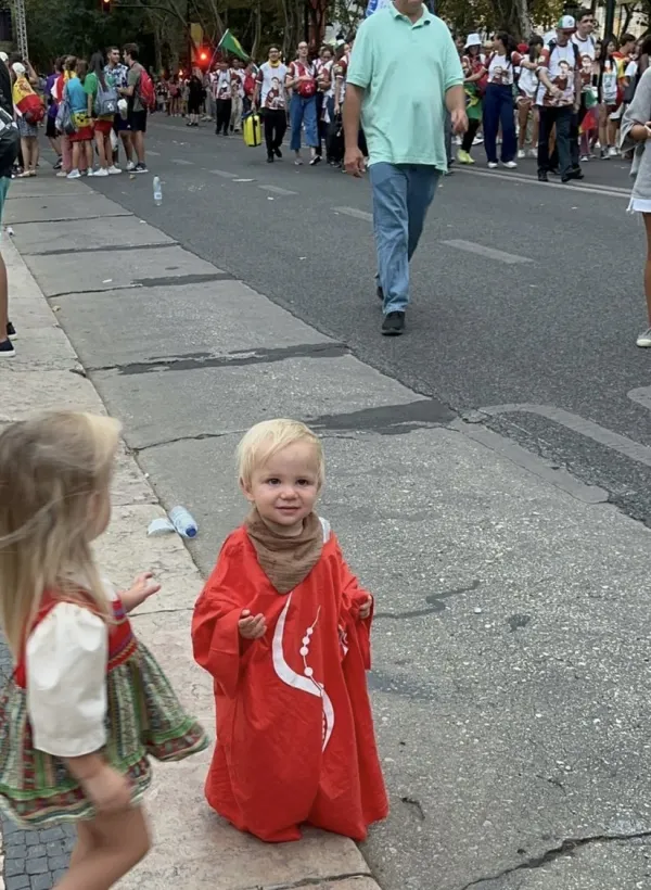 Edmund Love, the youngest family member, in the streets of Lisbon for World Youth Day 2023. Credit: Alexis Love