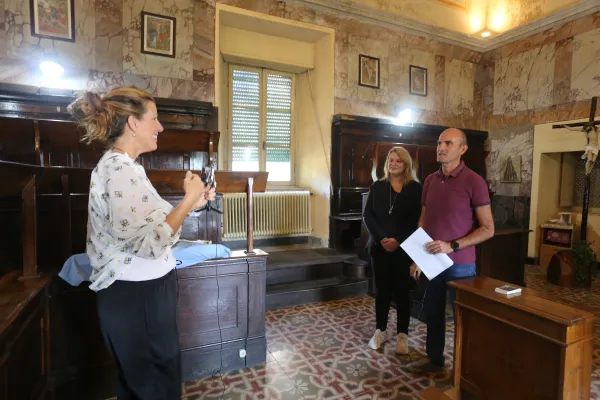 Susan Agostinelli interviews hobby cyclist Simone Durante and his wife, Maddalena, new devotees of Blessed Grimoaldo Santamaria, at the Passionist Abbey of Ceccano in October 2022. Durante believes his life was miraculously saved through the intercession of Grimoaldo after he was hit by a car in a devastating road accident on his bicycle on Jan. 27, 2021. Credit: Hannah Brockhaus/CNA