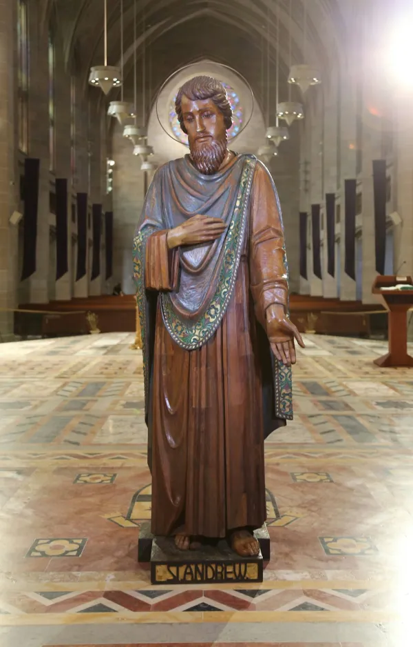 The statue of St. Andrew. Each of the statues were carved from a single tree trunk and rescued from St. Benedict Church in Highland Park, which closed in 2014. After undergoing extensive restoration, the statues were installed in the cathedral's nave in December 2023. Credit: Photo courtesy of Detroit Catholic