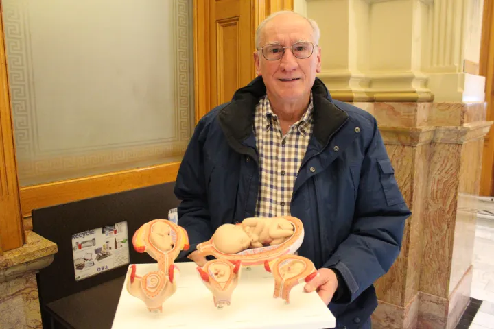 Dr. Tom Perille, a retired physician and president of the Democrats for Life of Colorado, holding a model showing preborn babies at various stages of development. Perille planned to testify against an abortion bill at the Colorado state capitol on March 9, 2022.