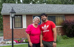 Ann Wittman with Farid Wardak, an Afghan immigrant, in front of the house that the Wittmans purchased for the Wardak family in the St. Louis suburb of Affton. Jonah McKeown/CNA