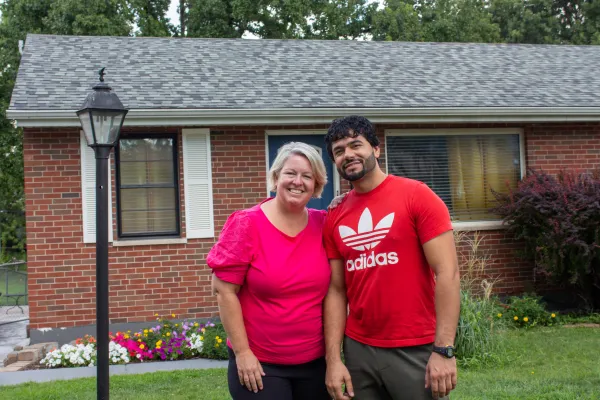 Ann Wittman with Farid Wardak, an Afghan immigrant, in front of the house that the Wittmans purchased for the Wardak family in the St. Louis suburb of Affton. Credit: Jonah McKeown/CNA