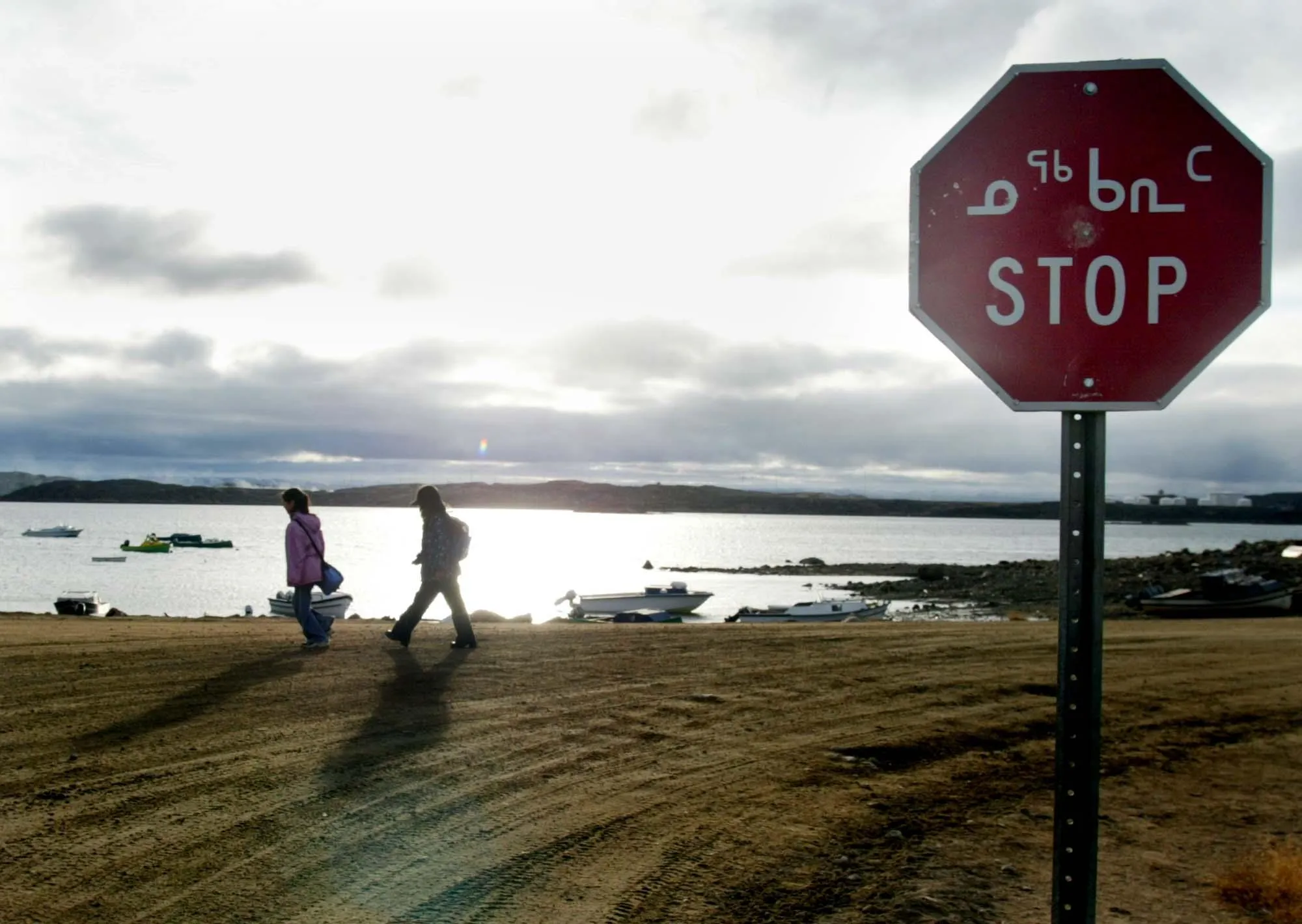 Two Inuit children return from school past a stop sign written in English in October 2002 in Iqaluit, northern Canada. Iqaluit is the capitol of Nunavut Territory in the Canadian Arctic.?w=200&h=150
