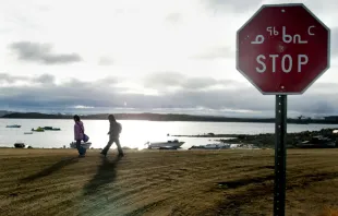 Two Inuit children return from school past a stop sign written in English in October 2002 in Iqaluit, northern Canada. Iqaluit is the capitol of Nunavut Territory in the Canadian Arctic. Andre Forget/AFP via Getty Images