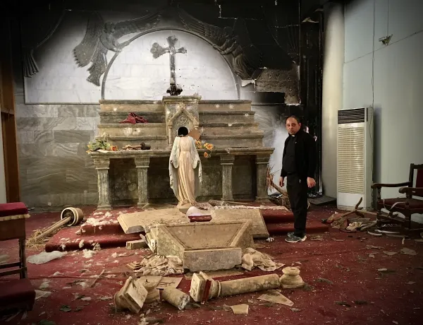 Father Thabet Habib Yousif Al Mekko (now a Chaldean Catholic bishop) in Karamles, Iraq, in October 2016, surveying the damage done to his church by the Islamic State. Courtesy of Stephen Rasche