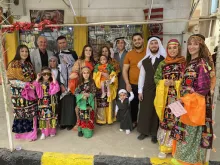 A Christian family in Qaraqosh sporting their traditional dressing for Holy Week in April 2022.