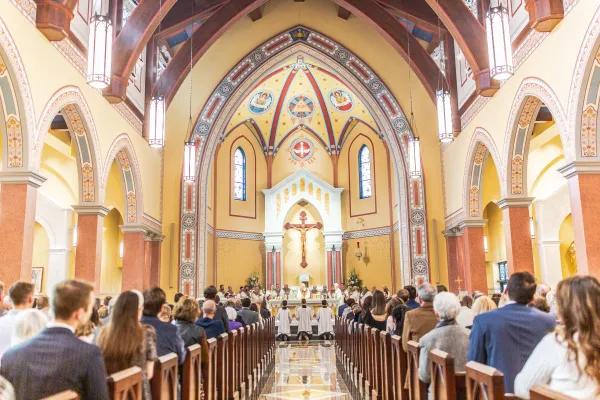 The congregation kneels during the dedication Mass for the new St. Isidore's Catholic Student Center at Kansas State University. Credit: Jacob Bentzinger