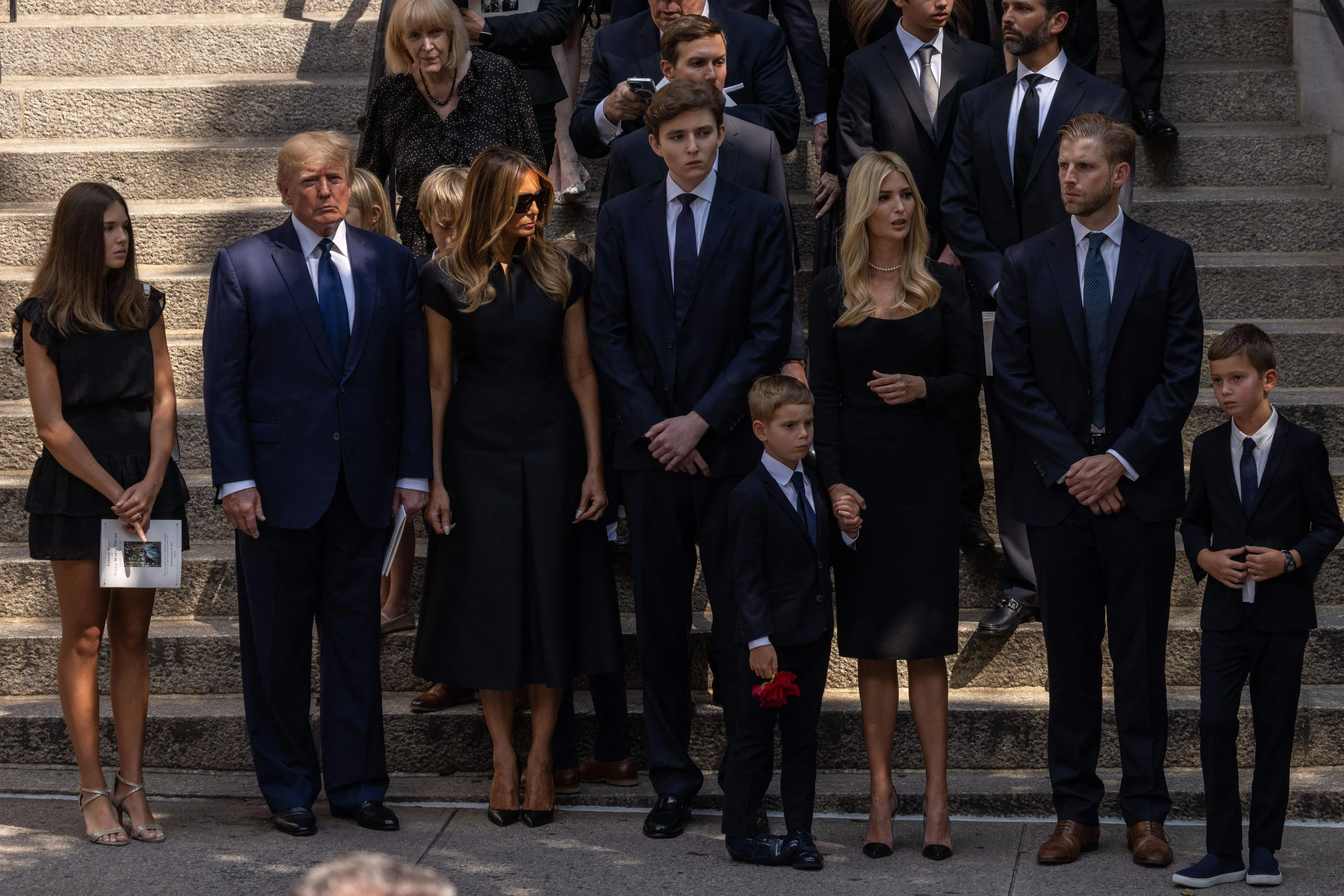 Former President Donald Trump, former First Lady Melania Trump, Barron Trump, Ivanka Trump, Eric Trump, and other relatives stand outside of St. Vincent Ferrer Roman Catholic Church after the funeral services of Ivana Trump in New York, on July 20, 2022.?w=200&h=150