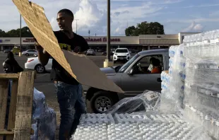 Dontavious Spann helps hand out cases of bottled water at a Mississippi Rapid Response Coalition distribution site on Aug. 31, 2022 in Jackson, Mississippi. Brad Vest/Getty Images