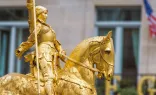 Side view of the gilded statue of Joan of Arc at Place des Pyramides in Paris, France.