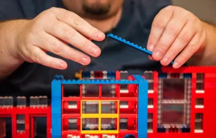 John Kraemer lays a brick while constructing his latest church. Catholic Diocese of Saginaw