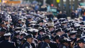 NYPD officers stand in line at the funeral of NYPD officer Jonathan Diller at St. Rose of Lima Catholic Church on March 30, 2024, in Massapequa, New York. Officer Diller was killed on March 25 when he was shot in Queens after approaching an illegally parked vehicle.