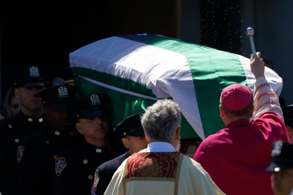 NYPD pallbearers carry the casket of NYPD officer Jonathan Diller as Rockville Centre Bishop John Barres blesses the casket at Diller’s funeral at St. Rose of Lima Catholic Church on March 30, 2024 in Massapequa, New York. Credit: Michael M. Santiago/Getty Images