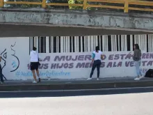 Young pro-life people paint a mural with messages opposing surrogate motherhood in Mexico.