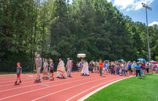 Pilgrims on the Juan Diego route of the National Eucharistic Pilgrimage process on a track in Georgia. Credit: Issy Martin-Dye