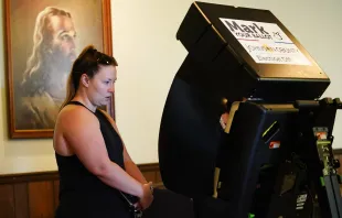 A poll worker helps a voter cast their ballot in the Kansas Primary Election at Merriam Christian Church on Aug. 2, 2022, in Merriam, Kansas. Voters in Kansas were set to decide whether or not the state constitution should include a right to an abortion. Kyle Rivas/Getty Images