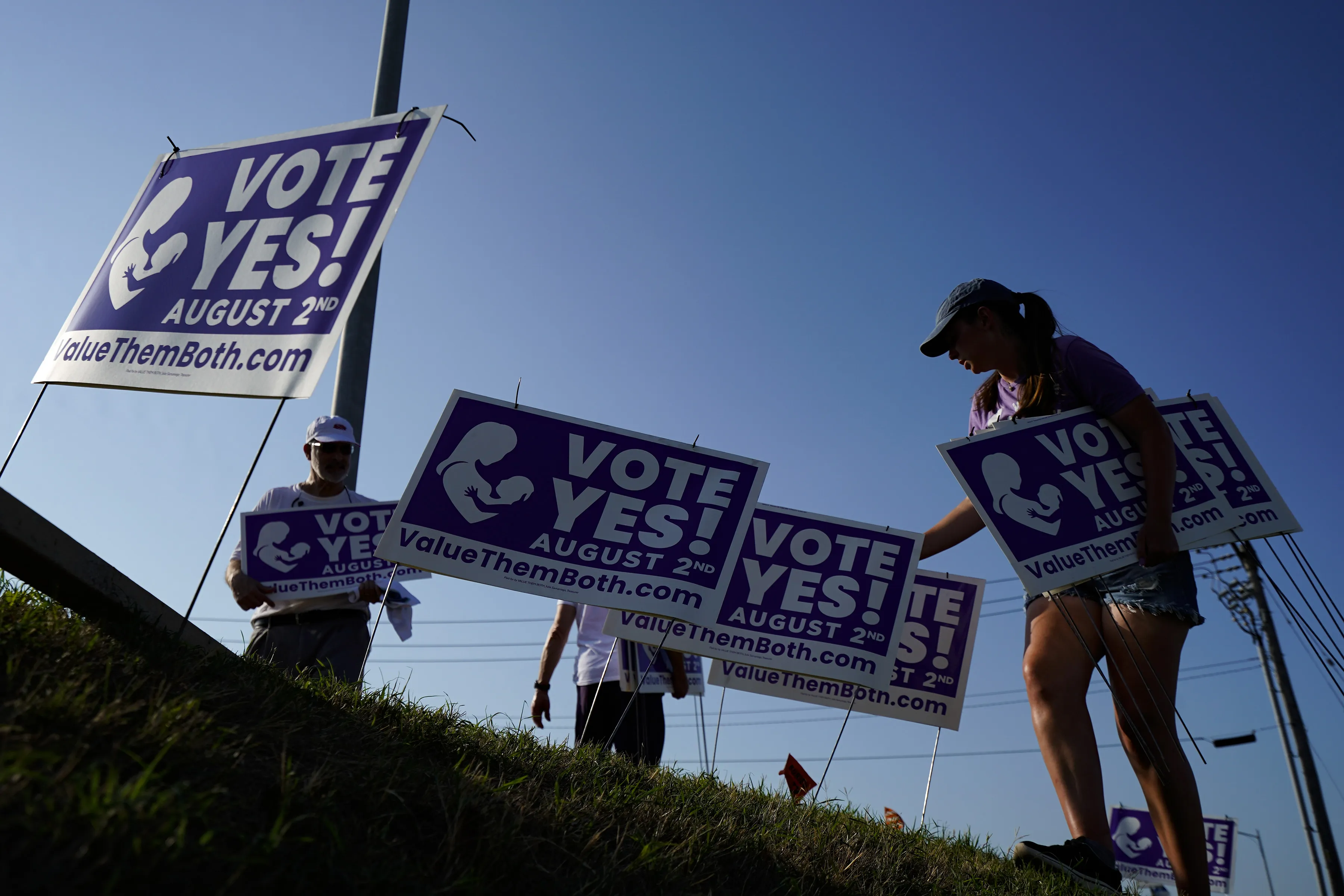 Supporters of the Vote Yes to a Constitutional Amendment on Abortion remove signs along 135th Street on Aug. 1, 2022, in Olathe, Kansas.?w=200&h=150